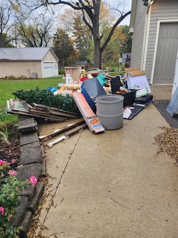 Dumpster being loaded with debris for Roofing Dumpster Rental in Merrill